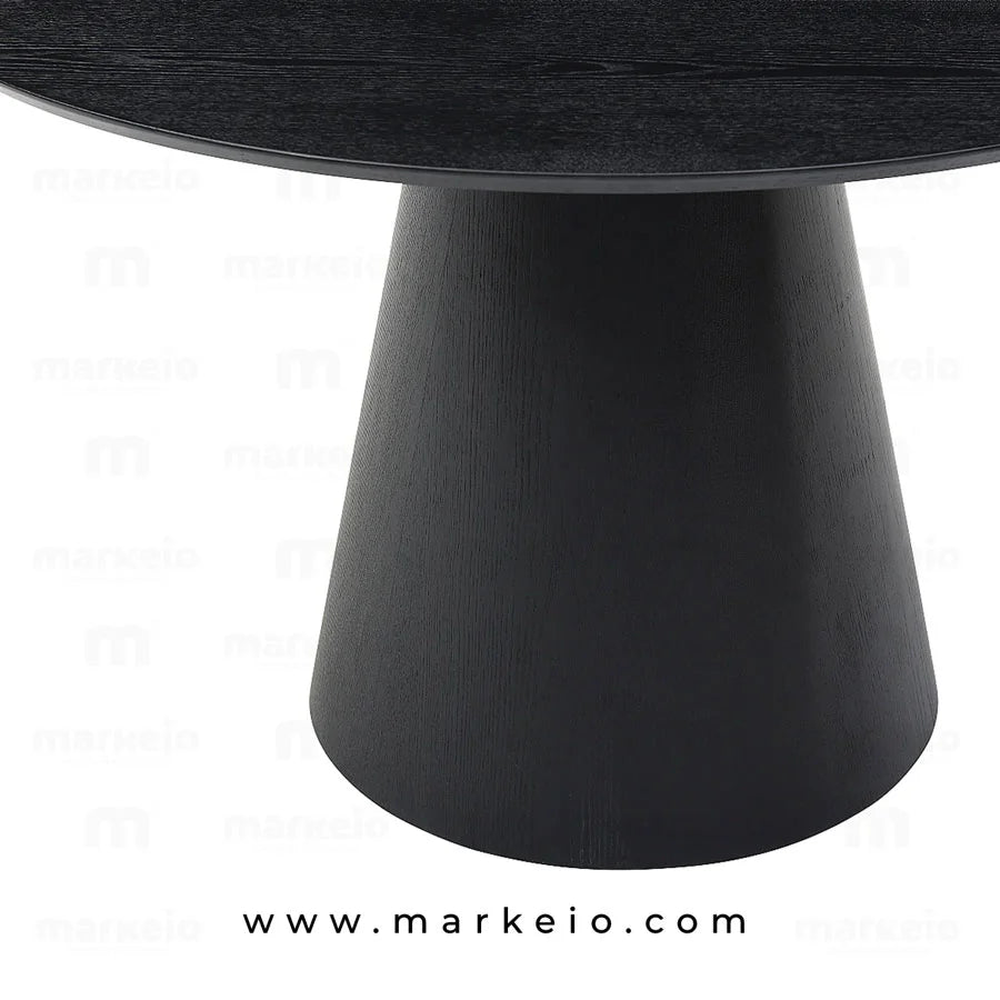Table de repas ronde noire au design sculptural pour intérieur moderne.