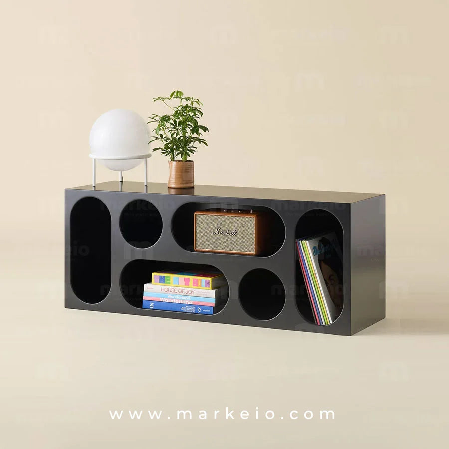 Console Onso noire avec ouvertures géométriques ovales et rondes.