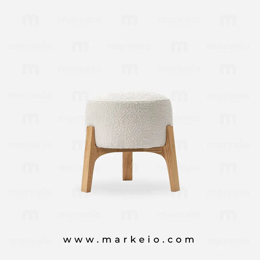 Tabouret rond texturé pour un salon au design contemporain.
